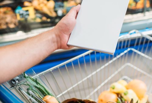 cropped-shot-of-man-holding-empty-notebook-while-s-2023-11-27-04-56-27-utc